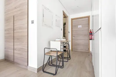 a kitchen with two stools and a counter in a room at StoneTree - Studio One Tower Studio - Amazing View and Facilities in Dubai