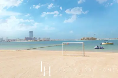 a soccer goal on a beach with a city in the background at LUX The Anantara Residence Suite in Dubai