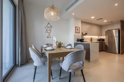 a kitchen and dining room with a table and chairs at Spacious 3BDR Townhouse I Garden I Tilal Al ghaf in Dubai
