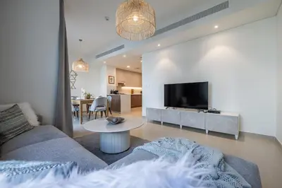 a living room with a couch and a table at Spacious 3BDR Townhouse I Garden I Tilal Al ghaf in Dubai