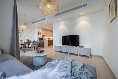 a living room with a couch and a table at Spacious 3BDR Townhouse I Garden I Tilal Al ghaf in Dubai