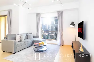 a living room with a couch and a table at LUX The JBR Marina View Suite 2 in Dubai