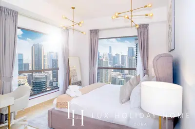 a bedroom with a large window with a city view at LUX The JBR Marina View Suite 2 in Dubai