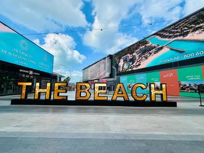 a sign that says the beach in front of a building at Huge fantastic 3 bedroom in Al Fattan Marine Tower in Dubai