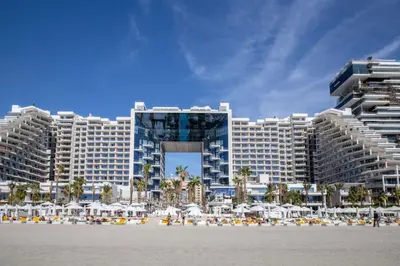 a large resort building with a beach in front of it at FIVE Palm North Residences - Spectacular Three Bedroom in Dubai