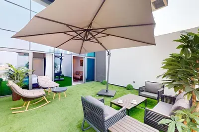 a patio with a table and an umbrella at 15 Northside Tower 2 - Spacious One Bedroom in Dubai