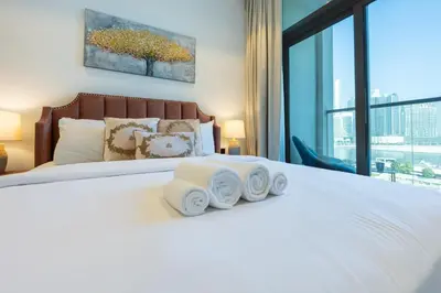 a bedroom with a white bed with towels on it at 15 Northside Tower 2 - Charming One Bedroom in Dubai
