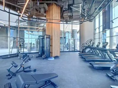 a gym with rows of treadmills and machines at 15 Northside Tower 2 - Charming One Bedroom in Dubai