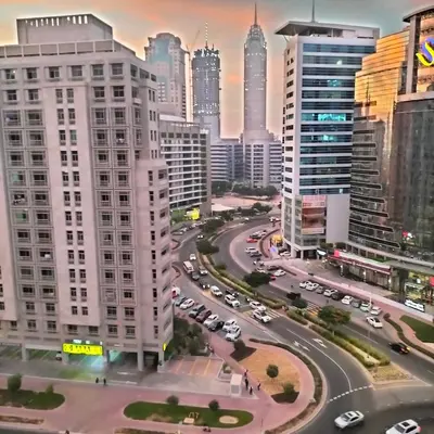 a city skyline with cars on a busy street at Private Studio Apartment in Tecom next to Metro station in Dubai