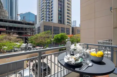 a table on a balcony with a view of a city at Frank Porter - Claren Tower in Dubai