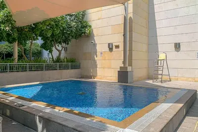 a swimming pool in the side of a building at Frank Porter - Claren Tower in Dubai