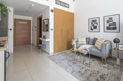 a living room with a couch and a table at Frank Porter - Claren Tower in Dubai