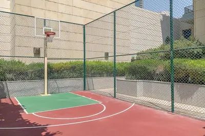 a court with a basketball hoop on a tennis court at Frank Porter - Claren Tower in Dubai