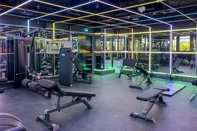 a gym with treadmills and machines in a room at Cozy Circle !Enjoyable Yet Affordable Studio Apartment! in Dubai