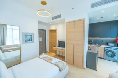 a bedroom with a bed and a living room at Cozy Circle !Enjoyable Yet Affordable Studio Apartment! in Dubai