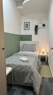 a bedroom with a bed with two towels on it at Beautiful Partition Room in Al barsha 1 Near Metro in Dubai