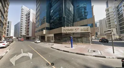 a city street with cars parked in front of a building at Beautiful Partition Room in Al barsha 1 Near Metro in Dubai