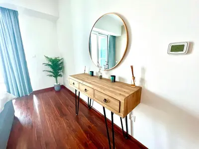 a bathroom with a mirror and a wooden dresser at The Waves 241 Dubai Marina in Dubai