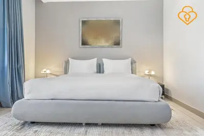 a bedroom with a white bed with two pillows at Keysplease Upgraded 4 BR Beach Villa W Private Beach, Palm in Dubai