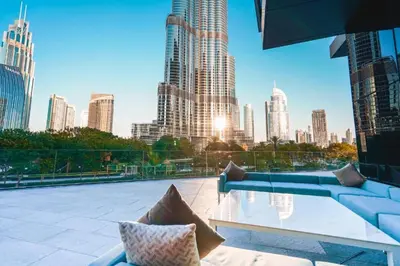 a rooftop patio with a view of a city skyline at Hotel Apartment Near Burj Khalifa - Opera T2 - شقة فندقية قريبة من برج خليفة اوبرا -برج 2 in Dubai
