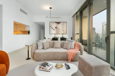 a living room with a couch and a table at Ultimate Stay Full Burj Khalifa & Downtown Views Designer Luxury High Floor connected to Dubai Mall for 4 People in Dubai