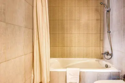 a bathroom with a bath tub and a toilet at Near to Iconic Miracle & Butterfly Garden Urban Vibe Studio, Lincoln Park A, Arjan-Dubailand by Deluxe Holiday Homes in Dubai