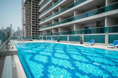 a swimming pool on the roof of a building at The Elite Apartment in Dubai
