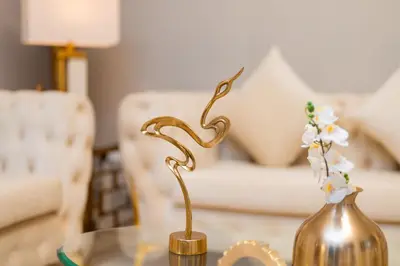 a table with a vase and a gold statue on it at Elite Royal Apartment - Full Burj Khalifa & Fountain View - Luxurious - Largest Layout - Melchior in Dubai