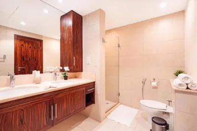 a bathroom with a sink and a toilet and a mirror at Elite Royal Apartment - Full Burj Khalifa & Fountain View - Luxurious - Largest Layout - Melchior in Dubai