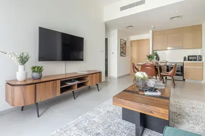 a living room with a flat screen tv on the wall at Frank Porter - Summer at Creek Beach in Dubai