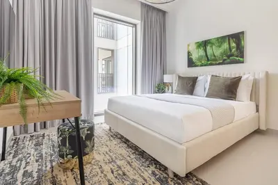 a white bedroom with a large bed and a window at Frank Porter - Summer at Creek Beach in Dubai