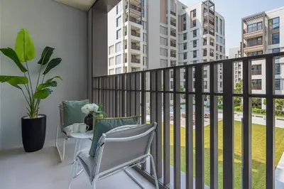 a balcony with chairs and a view of buildings at Frank Porter - Summer at Creek Beach in Dubai