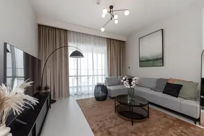 a living room with a couch and a table at Luxury apartments at Vida Residences in Dubai
