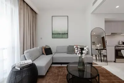 a living room with a couch and a table at Luxury apartments at Vida Residences in Dubai