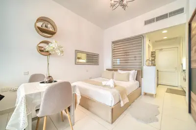 a bedroom with a bed and a table and a dining room at Studio in Palm Views West at Palm Jumeirah by PK Holidays in Dubai