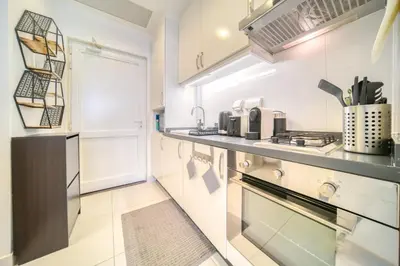 a kitchen with white walls and a counter top at Studio in Palm Views West at Palm Jumeirah by PK Holidays in Dubai