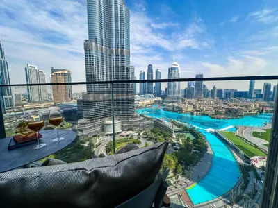 a view of a city from a balcony with wine glasses at Address Residence Dubai Opera 21 by Luxstay Holiday Homes in Dubai