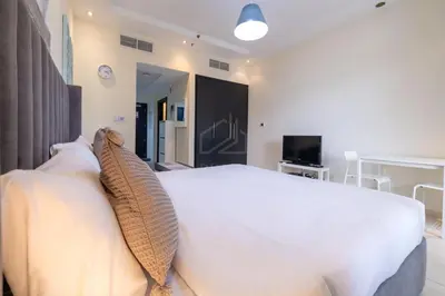 a bedroom with a large white bed with two pillows at Very nice studio in Skyview Tower Dubai Marina in Dubai