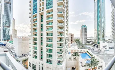 a view of a tall building with a pool at Very nice studio in Skyview Tower Dubai Marina in Dubai