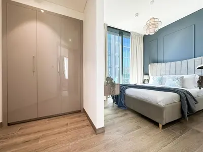 a bedroom with a large bed and a large closet at Trophy - Alfresco 2BDR Suite in Dubai