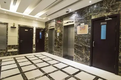 a bathroom with black doors and marble walls at Loft Style Partition Room in Shared Apartment in Al Barsha 1 Near MOE Metro in Dubai