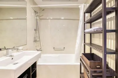 a bathroom with a sink and a tub and a shower at Spacious 1BR in Botanica tower with sea view by PK holidays in Dubai