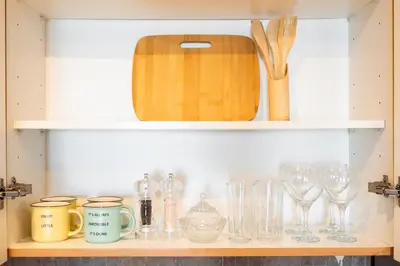 a shelf with glasses and other items on it at Modern Studio Lake View JLT Near Marina & Metro in Dubai