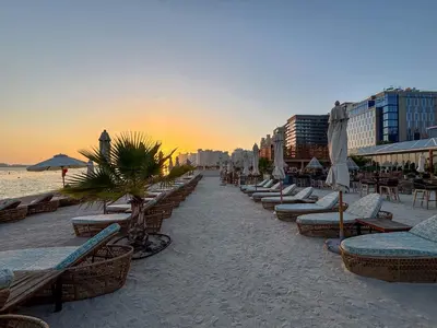 a beach with chairs and umbrellas on the beach at Frank Porter - Seven Hotel & Aprtments in Dubai