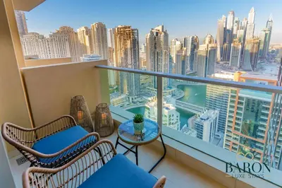 a balcony with two chairs and a view of a city at The Urban in Dubai