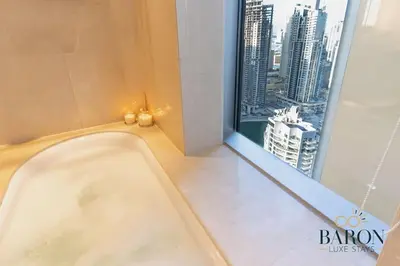 a bath tub in a bathroom with a large window at The Urban in Dubai