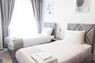 a hotel room with two beds and a window at Shams Beach Front JBR apartments by HAPPY SEASON in Dubai