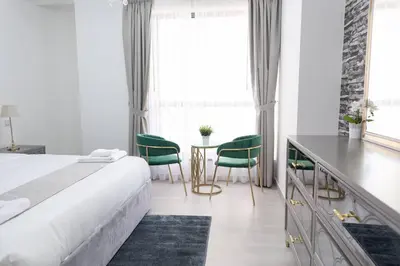 a bedroom with a bed and a table and chairs at Shams Beach Front JBR apartments by HAPPY SEASON in Dubai