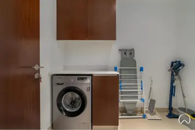 a kitchen with a washing machine in a room at Oraya - Stunning 2BR- Mulberry Dubai Hills, Pool-Park view in Dubai