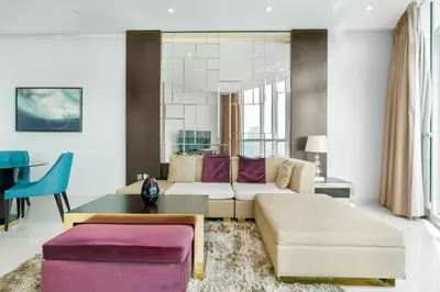 a living room with a couch and a table at Lux BnB Upper Crest Tower I Skyline Views in Dubai